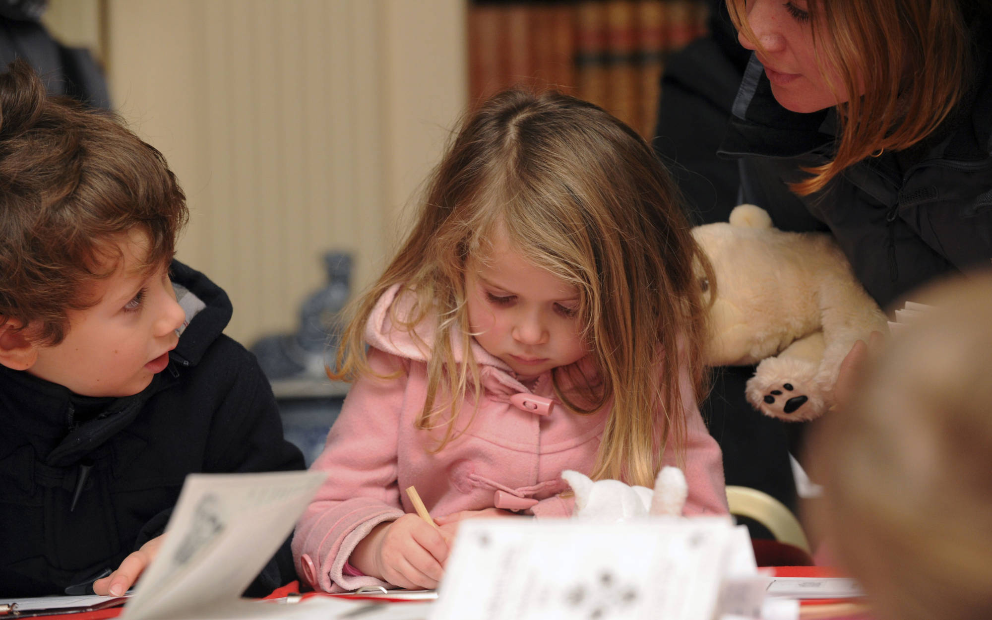 small child writing a letter to father christmas