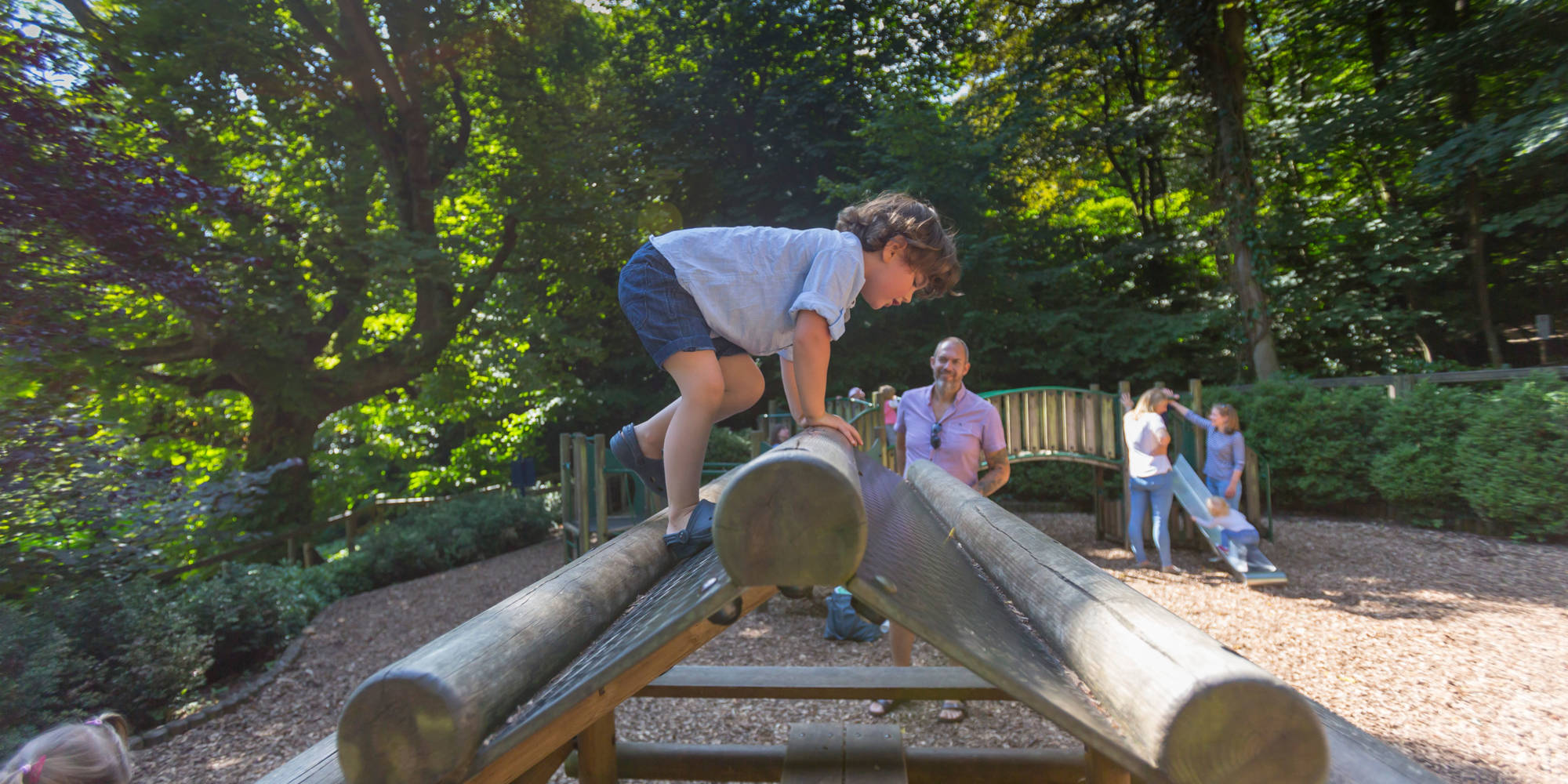 A young visitor using the climbing frame