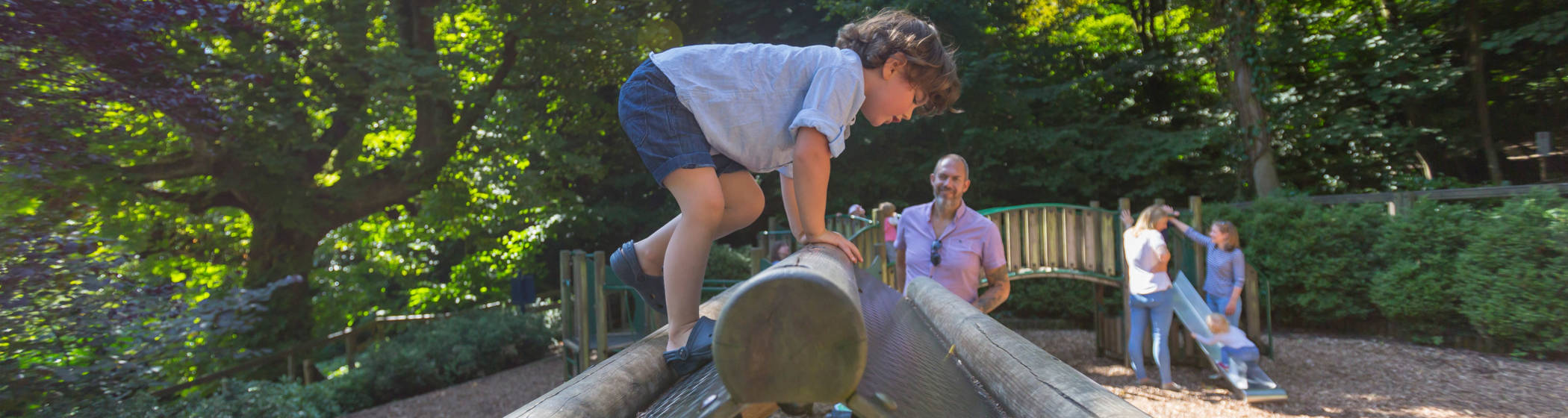 A young visitor using the climbing frame