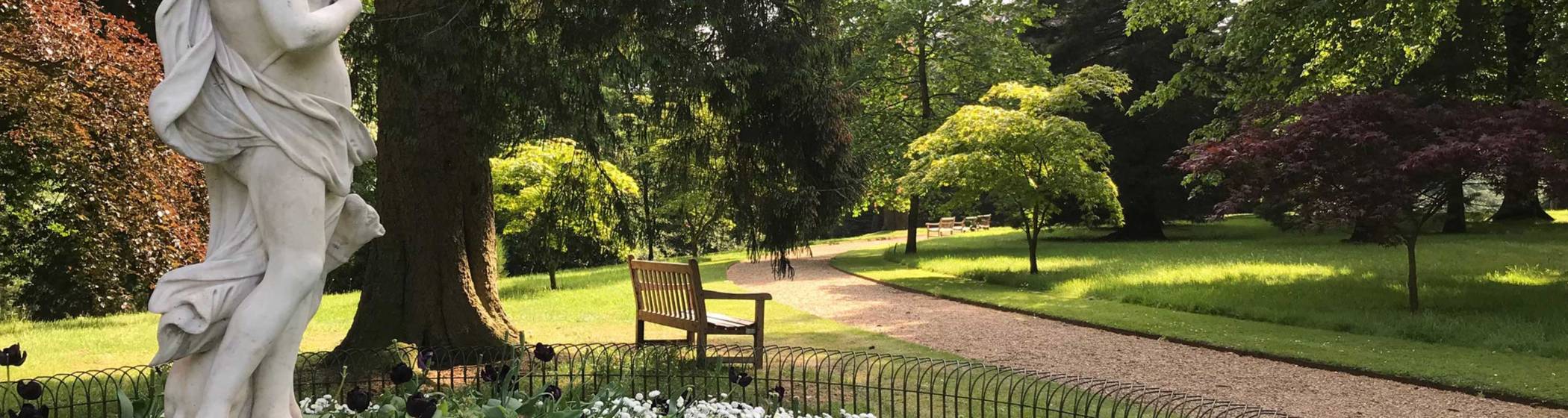 Half moon path in the gardens with statue