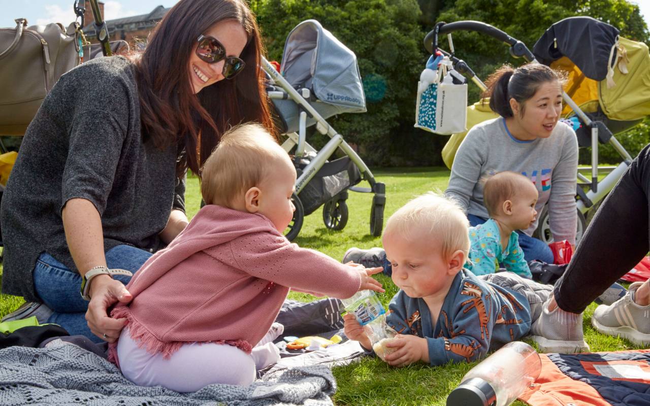 A family with young children enjoying a picnic