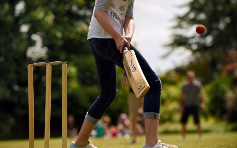 Young child playing cricket