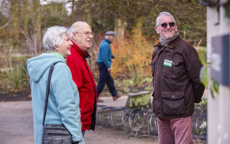 Volunteer speaking with visitors at Dunham Massey, Cheshire